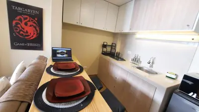 a kitchen with a table with a hat and a sink at Munay hospedaje in Cusco