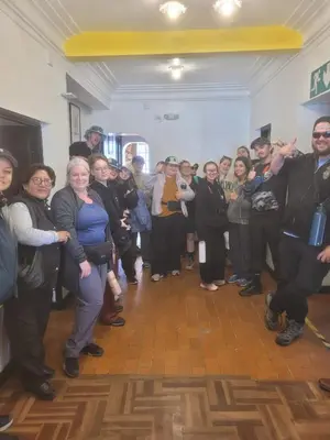 a group of people standing in a room at HOTEL HUAYNAPATA Pardo in Cusco
