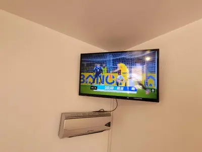 a flat screen tv hanging on a wall at HOTEL HUAYNAPATA Pardo in Cusco