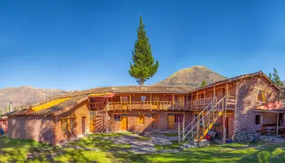 a house with a tree on top of it at Hospedaje Pumayalli in Urubamba