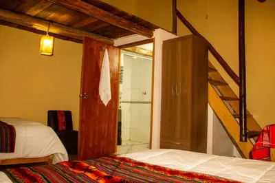 a bedroom with a ladder leading to a shower at Hospedaje Pumayalli in Urubamba