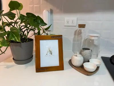 a picture frame on a counter with a plant and vases at Art08 Milu - Miraflores Cerca de Larcomar in Lima