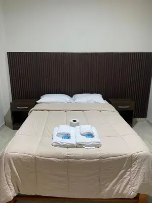 a bed with two towels on top of it at Mablia Suite in Ica