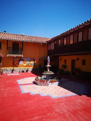 a courtyard with a fountain in the middle of a building at Inka Tambo Hacienda in Cusco