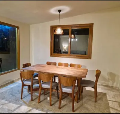 a wooden table and chairs in a room at Tornameza Casa de Campo in Torna Mesa