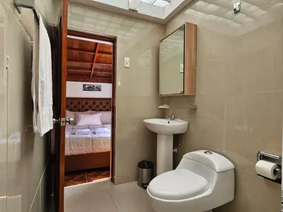 a small bathroom with a toilet and a sink at SAMAY WASI b&b in Cusco