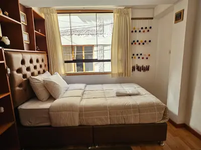 a bedroom with a bed with a window at SAMAY WASI b&b in Cusco