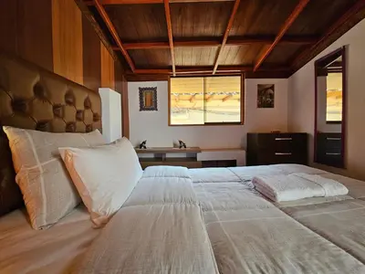 a bedroom with a large bed with white pillows at SAMAY WASI b&b in Cusco