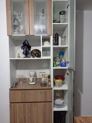 a pantry with a wooden counter in it at Apartment 12 min from airport in Lima