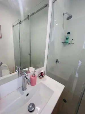 a bathroom with a sink and a glass shower at departamento nuevo con espectacular vista entre surco y Miraflores in Lima