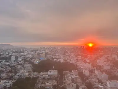 a view of a city with the sun setting at departamento nuevo con espectacular vista entre surco y Miraflores in Lima