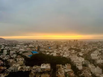 an aerial view of a city at sunset at departamento nuevo con espectacular vista entre surco y Miraflores in Lima