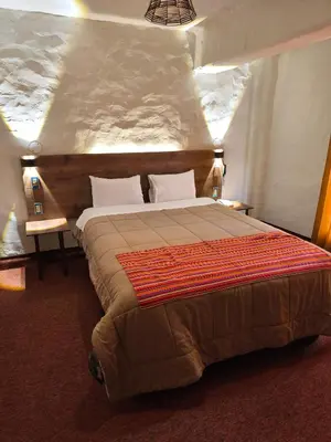a bedroom with a large bed in a room at Waalay Hotel in Huancayo
