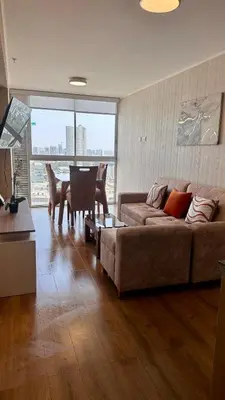 a living room with a couch and a table at Apartment in front of the Ricardo Palma Clinic in Lima