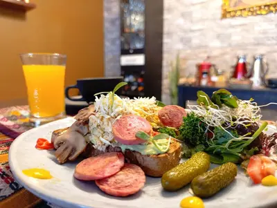 a plate of food with meat and vegetables on a table at The Culinary Stay and Taste in Cusco