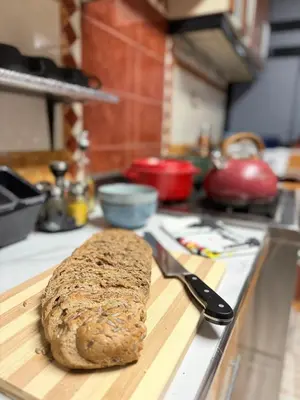 a loaf of bread on a cutting board with a knife at The Culinary Stay and Taste in Cusco