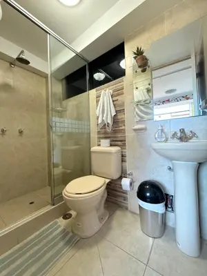 a bathroom with a toilet and a shower and a sink at The Culinary Stay and Taste in Cusco