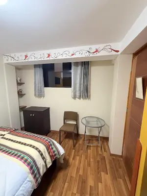 a bedroom with a bed and a glass table at The Culinary Stay and Taste in Cusco