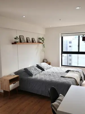 a bedroom with a bed and a desk and a window at Craviz house ,a home away from home in Lima