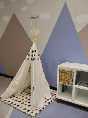 a teepee tent in a room with a book shelf at Craviz house ,a home away from home in Lima