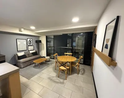 a living room with a table and a couch at San Isidro 1 Bedroom RN in Lima