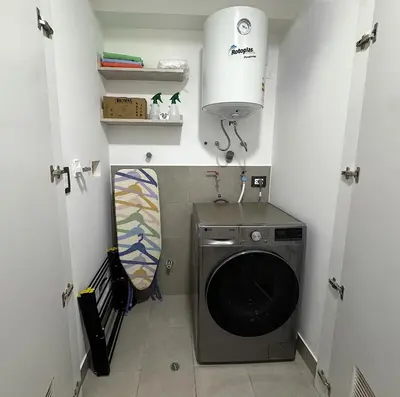 a small laundry room with a washing machine in it at San Isidro 1 Bedroom RN in Lima