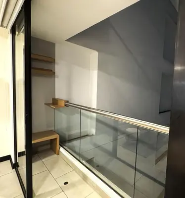a room with a glass railing and a staircase at San Isidro 1 Bedroom RN in Lima