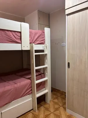 a pair of bunk beds in a small room at Departamento Palmeras in Lima