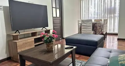 a living room with a large flat screen tv at Departamento centrico cusco in Cusco