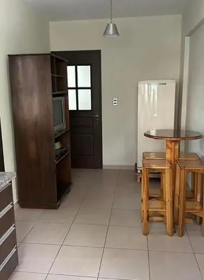 a kitchen with a table and chairs and a tv at Departamento centrico cusco in Cusco