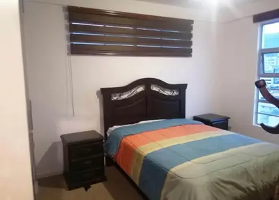a bedroom with a bed with a colorful blanket at Apartment in cusco center in Cusco