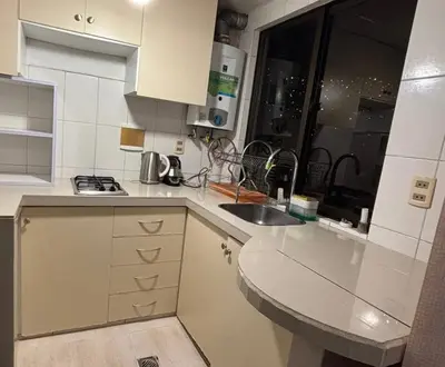 a white kitchen with a sink and a window at Apartment in cusco center in Cusco