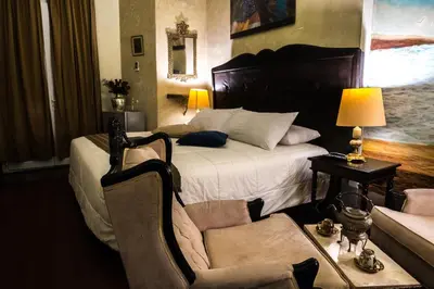 a bedroom with a bed and a chair and a couch at Casa Falleri Boutique Hotel in Lima