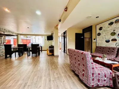 a living room with couches and a dining room at Hotel la Casa de Makito's in Cusco