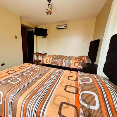 a hotel room with two beds in a room at Hotel la Casa de Makito's in Cusco