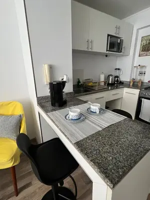 a kitchen with a table with two cups on it at Apartamento en Santa Beatriz in Lima