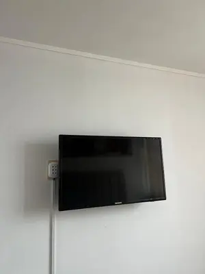 a flat screen tv hanging on a wall at Apartamento en Santa Beatriz in Lima