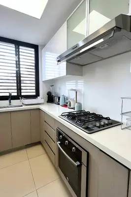 a kitchen with a stove top oven next to a sink at Luxury apartment in Miraflores near Larcomar in Lima