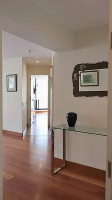 a room with a glass table and a hallway at Luxury apartment in Miraflores near Larcomar in Lima