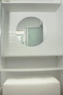 a white bathroom with a mirror and a stool at Lovely Apartment-Punta Hermosa in Punta Hermosa