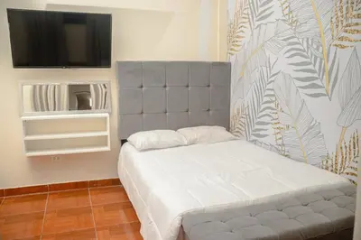 a bedroom with a bed and a flat screen tv at Lovely Apartment-Punta Hermosa in Punta Hermosa