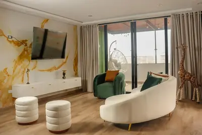 a living room with a white couch and a giraffe at Luxurious Apt with Rooftop, BBQ, and Beach nearby in Punta Hermosa