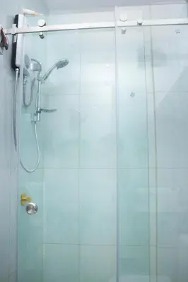 a glass shower stall with a glass door at Luxurious Apt with Rooftop, BBQ, and Beach nearby in Punta Hermosa