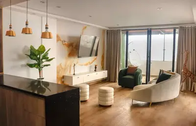 a living room with a couch and a chair at Luxurious Apt with Rooftop, BBQ, and Beach nearby in Punta Hermosa