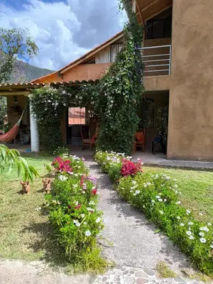 a garden with flowers in front of a building at Tikary Lodge in Cusco