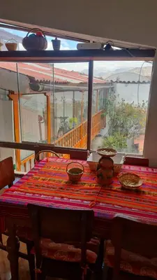 a table with bowls on it with a view of a balcony at Minidepartamento amoblado in Cusco