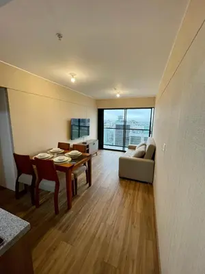 a living room with a table and a couch at Depa en Av Javier Prado frente a San isi in Lima