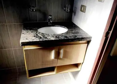 a bathroom with a sink and a granite counter top at chaski apart in Cusco