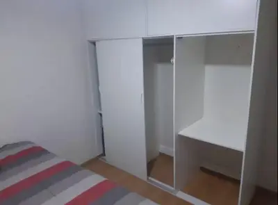 a white room with a bed and a desk at Varela Piso 12 in Lima
