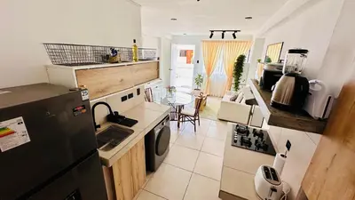 a kitchen with a black refrigerator and a table at Apartamentos Boho in Punta Hermosa